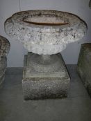 An old garden urn on stand.