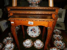 A nest of 3 tables with glass tops.