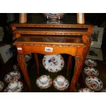 A nest of 3 tables with glass tops.