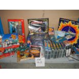 A large shelf of Fireball and Joe 90 toys and videos etc.