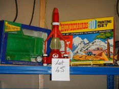 A shelf of Thunderbird items including 3D painting set etc.