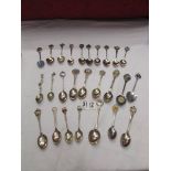 26 assorted souvenir spoons.