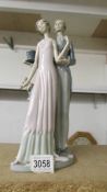 A Lladro figure group of a couple in evening dress.