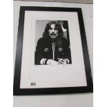 A framed limited edition photograph of George Harrison, 52/500.