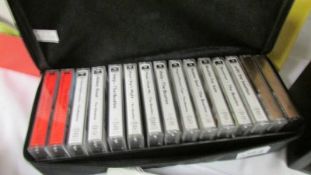 A small display unit with set of Beatles cassette tapes.
