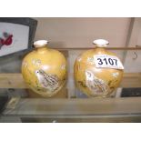 A pair of signed oriental pomegranate vases hand painted with birds, both a/f.