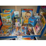 A large shelf of Thunderbird books, magazines, videos, posters etc.
