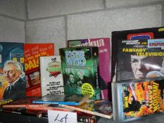 One shelf of assorted Doctor Who books and memorabilia etc.