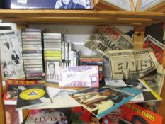 A shelf of Elvis cassettes, CD's and other memorabilia.