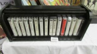 A small display unit with all 14 Beatles albums on cassette.
