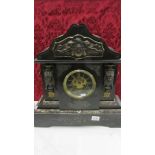 A Victorian black marble mantle clock with ormolu mounts.