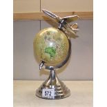 A political reference globe on polished aluminium aeroplane stand.