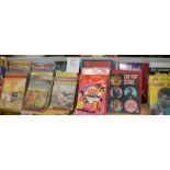 A long shelf of annuals including I Spy, Radio Caroline, Boys World etc.