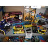 A shelf of assorted Batman toys including Batjet etc.