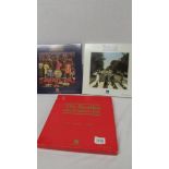 Three The Beatles on compact disc being Sgt Pepper, Abbey Road and a set of 3 Help,