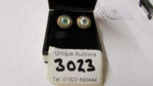 A pair of unusual 'All seeing eye' silver stud earrings.