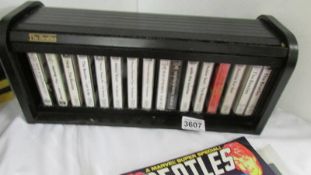 A display case of 16 Beatle cassette tapes.