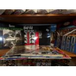 A shelf of assorted Beatles LP records.