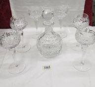 A crystal decanter and 6 wine goblets.