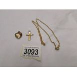 A yellow metal locket, cross and chain.