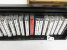 A display case of 14 Beatles cassette tapes.