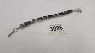 A purple stone set bracelet in silver.