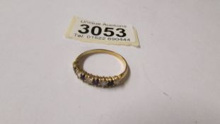 An 18ct gold ring set amethysts and diamonds, size W, total weight 3 grams.