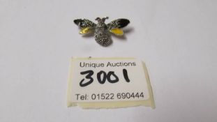 A silver marcasite and enamel bee brooch.