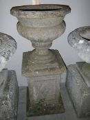 A tall garden urn on stand.
