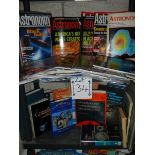 Two shelves of astronomy related books and magazines.