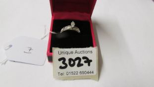 A diamond set marquise shaped ring with channel cut shoulders, marked 925. Size M.