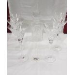 A crystal decanter and 6 cocktail glasses.