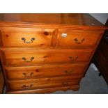 A satin walnut 2 over 3 chest of drawers.