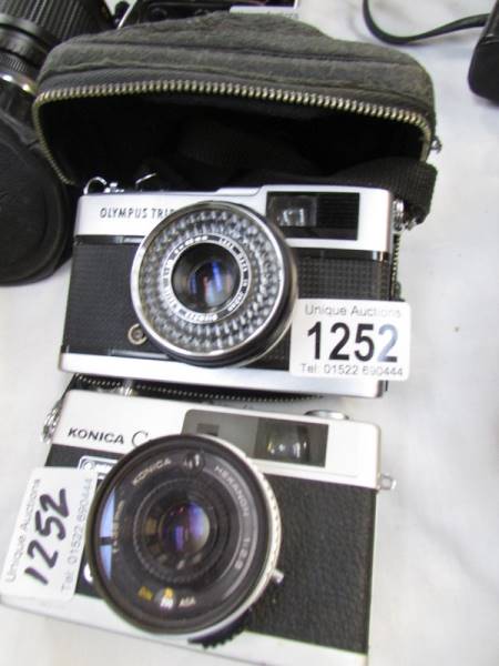 A Konica C35 camera and an Olympus Trip 35 camera.