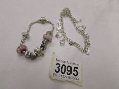 A modern silver charm bracelet and a Pandora style bracelet.