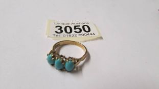 A 9ct gold ring set turquoise coloured stones, size S. Total weight 3.4 grams.