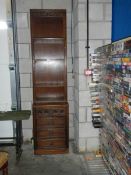 A tall and slim mahogany bookcase.