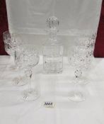 A crystal decanter and 6 wine goblets.