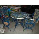 A metal circular garden table and 2 chairs,