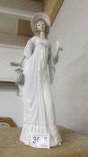 A tall Lladro figure of a lady.