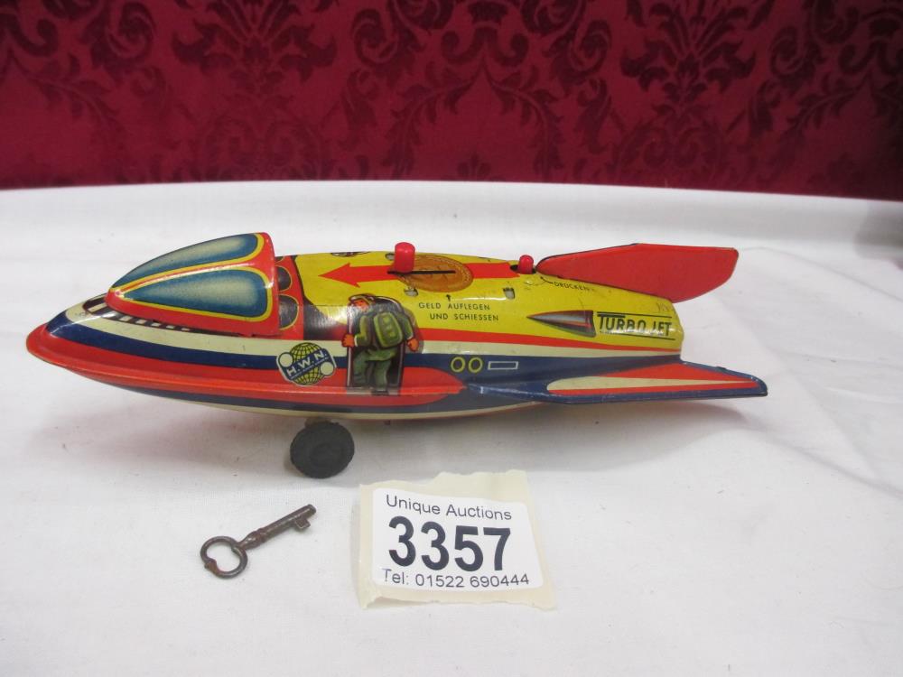 A HWN Rocket Mechanical Bank with key - tinplate West Germany - firing mechanism functions well