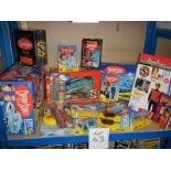 A shelf of Captain Scarlett toys including figures, DVD's etc.