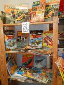 Three shelves of interesting books and magazines including Lion annuals, Thunderbirds etc.