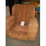 An Edwardian arm chair, missing cushion.