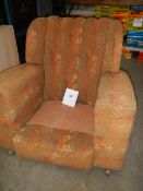 An Edwardian arm chair, missing cushion.