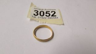A 22ct gold wedding ring, size N, 2 grams.