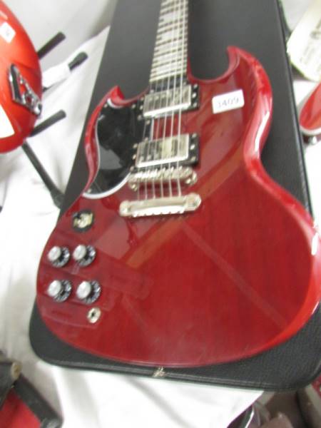 An Epiphone SG left hand pro guitar with hard case.