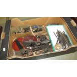 A box of vintage tools including planes, tape measures etc.