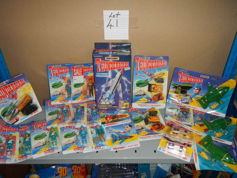 A large shelf of assorted Thunderbird toys,.
