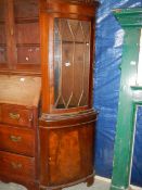 A mahogany corner cupboard.